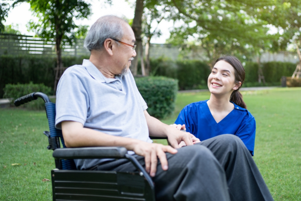 Caregiver assisting patient with physical disability